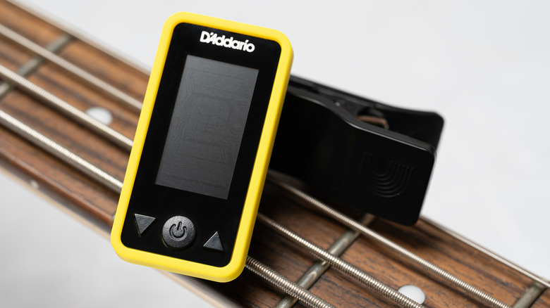 Un accordeur sur une guitare acoustique