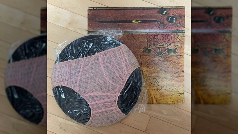 Alice Cooper "L'école est finie" album avec le disque enveloppé de sous-vêtements, posé sur un plancher en bois